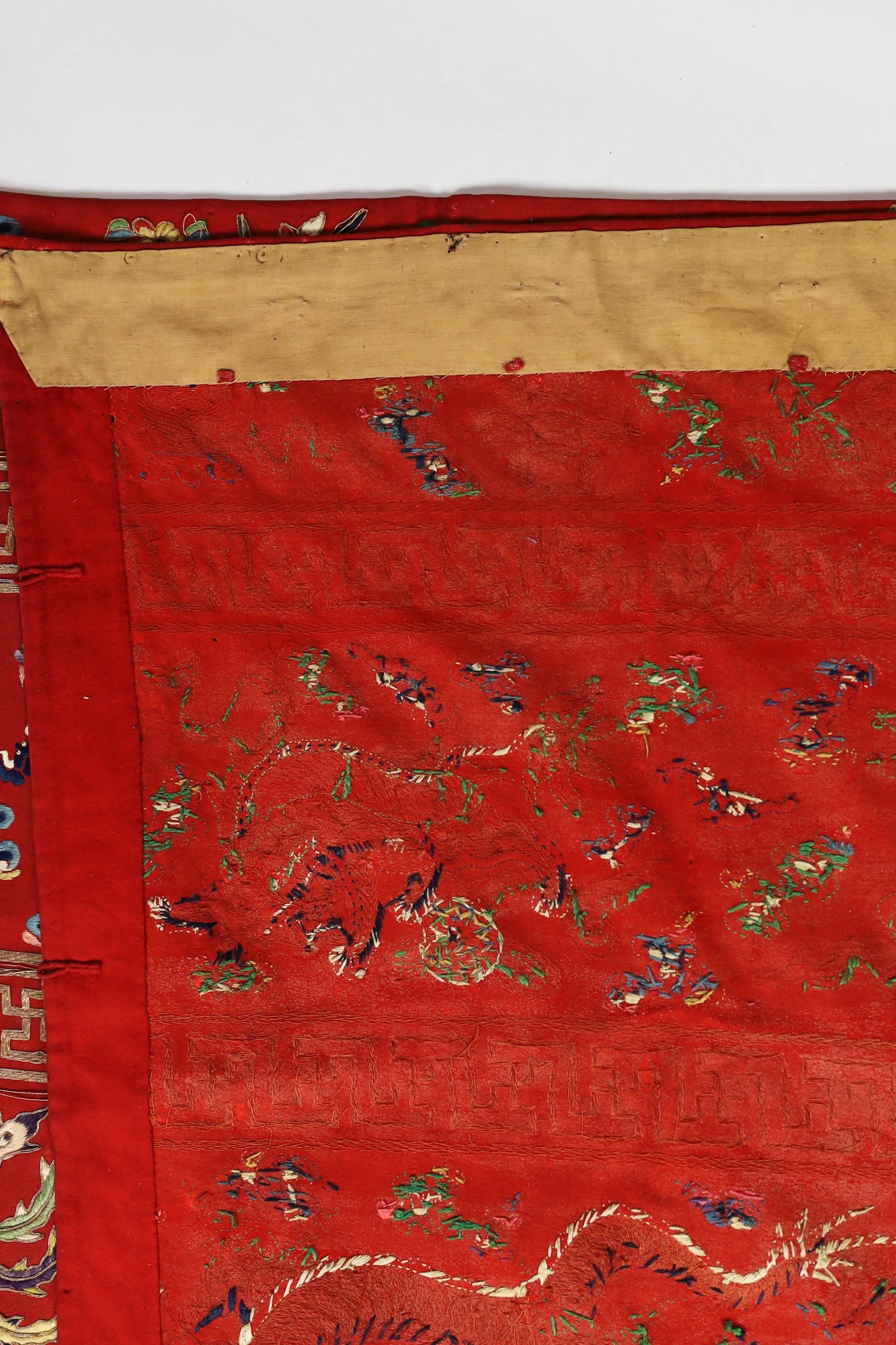 A Chinese embroidered silk ‘dragon, phoenix and lion’ panel or table frontal, late Qing dynasty, 117cm x 337cm